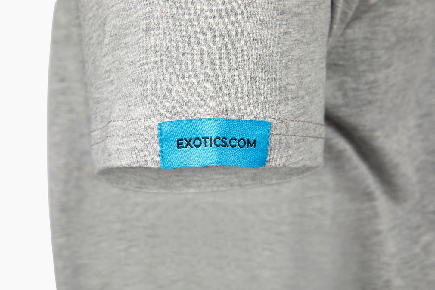 Gray Exotics tee t-shirt with blue tag on left sleeve