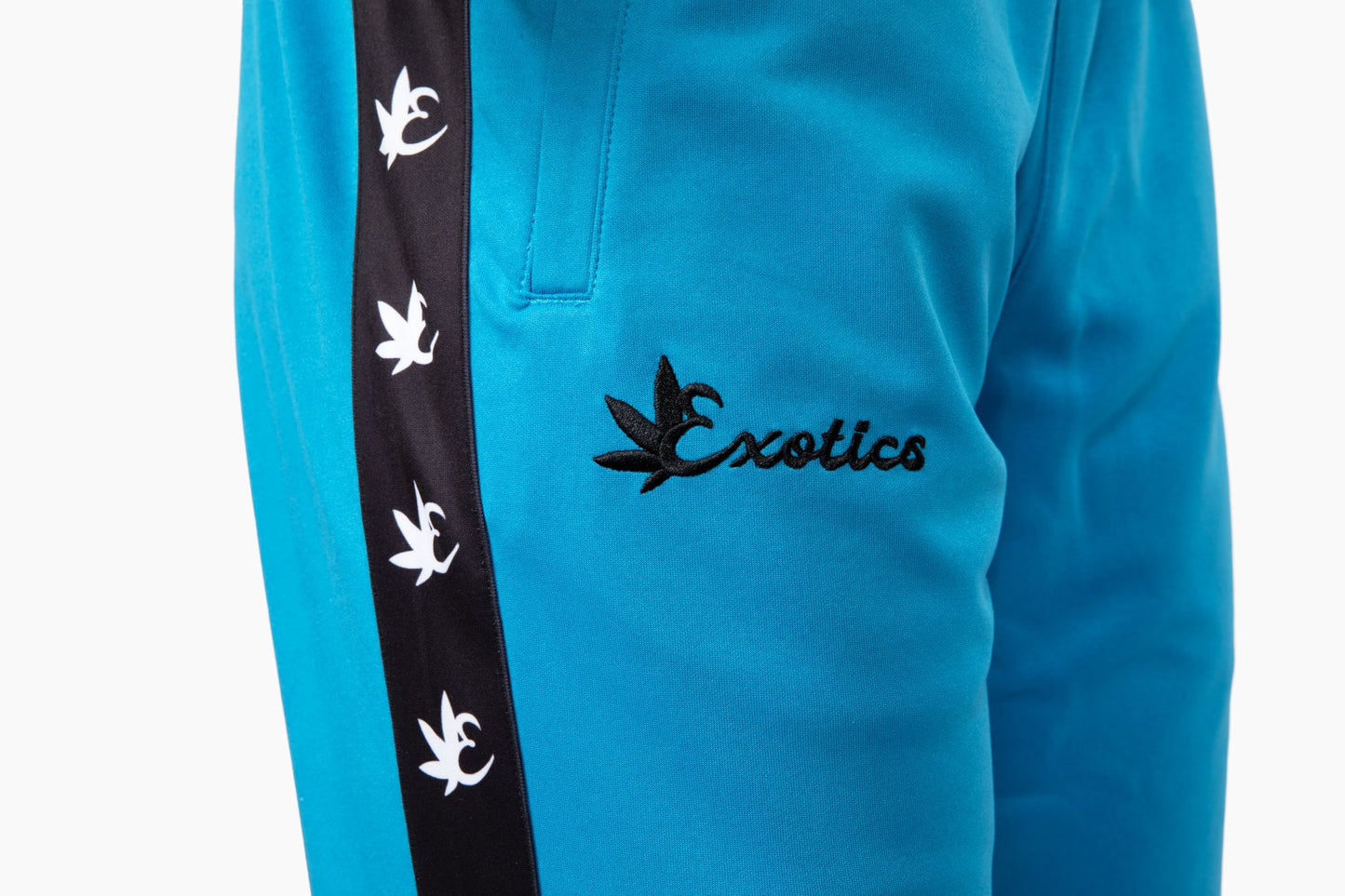 Close-up of blue Exotics tracksuit logo