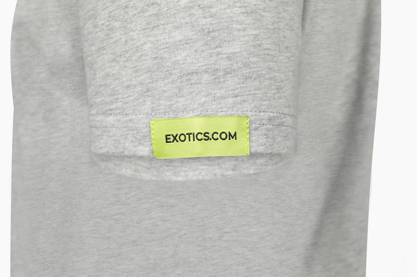 Gray Exotics tee t-shirt with green tag on left sleeve