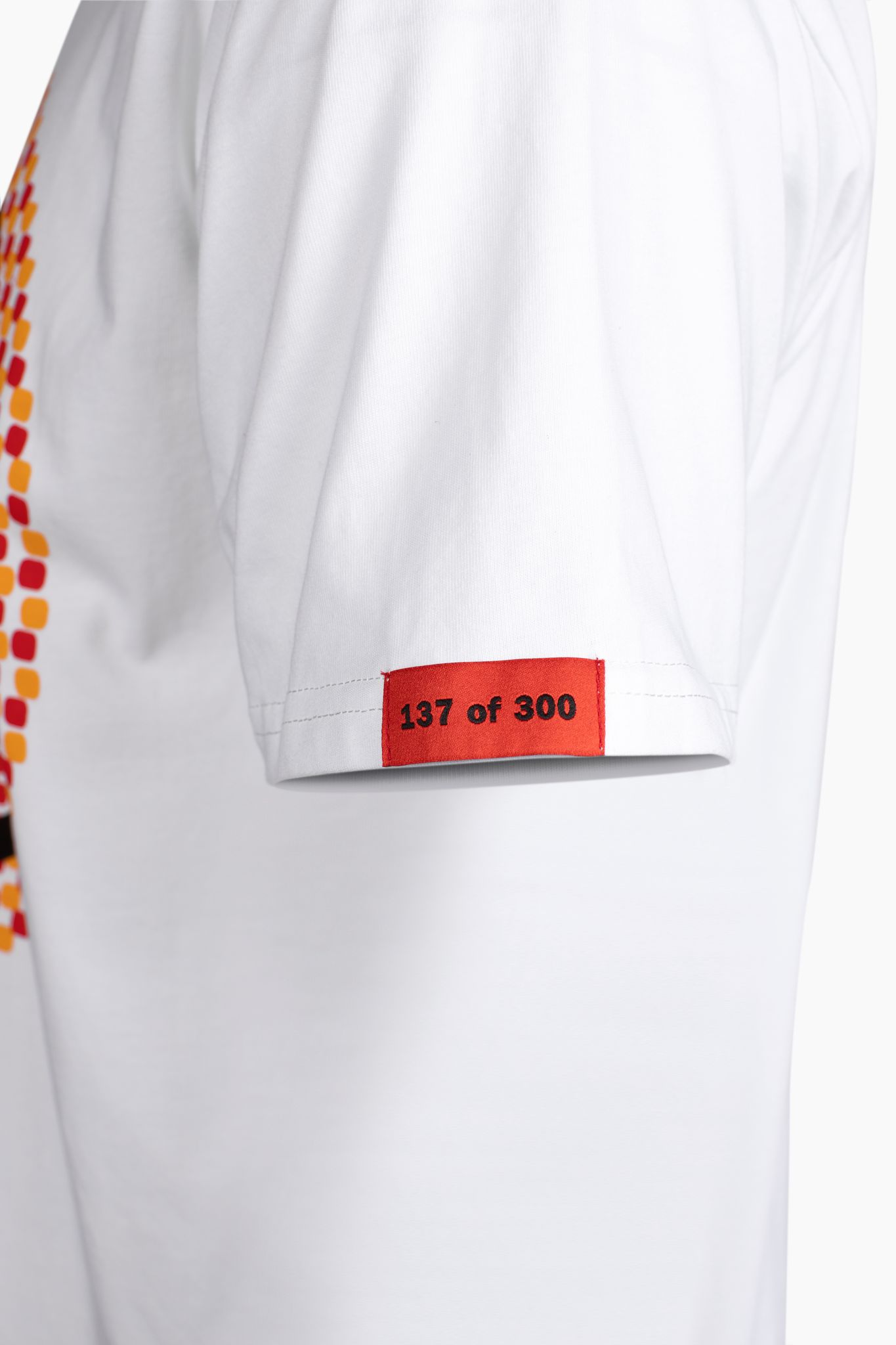 Red sleeve tag on white Exotics Induce tee t-shirt