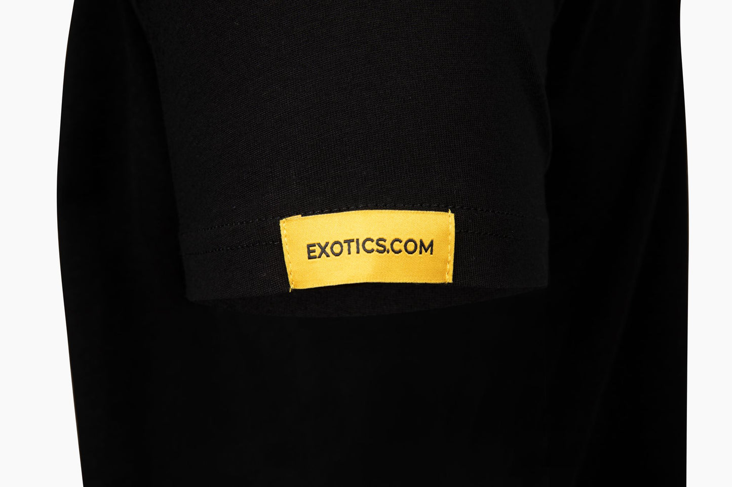 Black Exotics tee t-shirt with orange tag on left sleeve