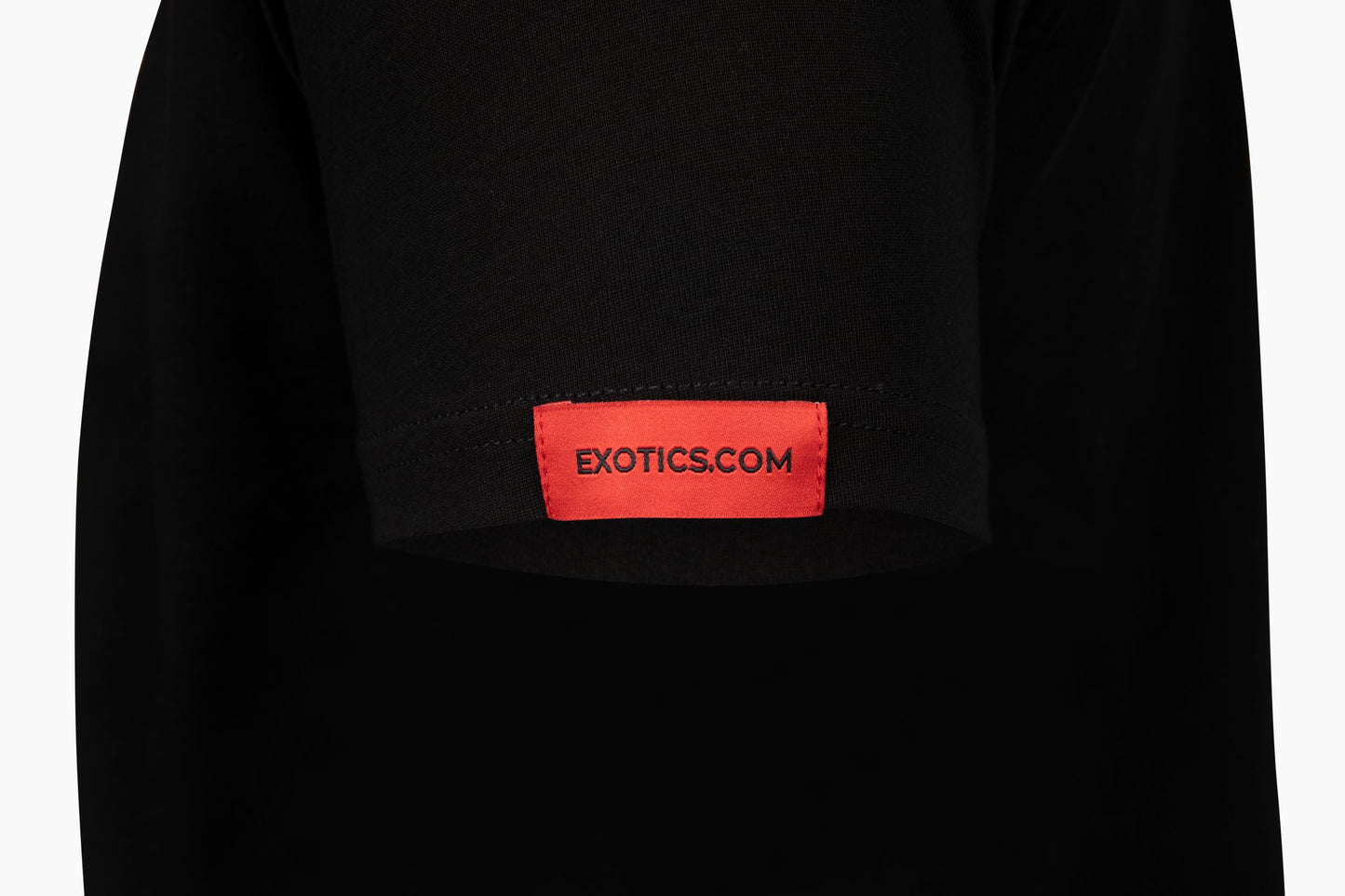 Black Exotics tee t-shirt with red tag on left sleeve
