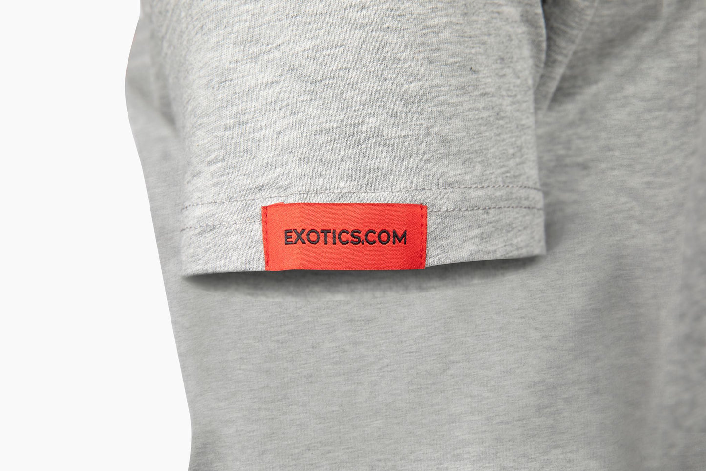 Gray Exotics tee t-shirt with red tag on left sleeve