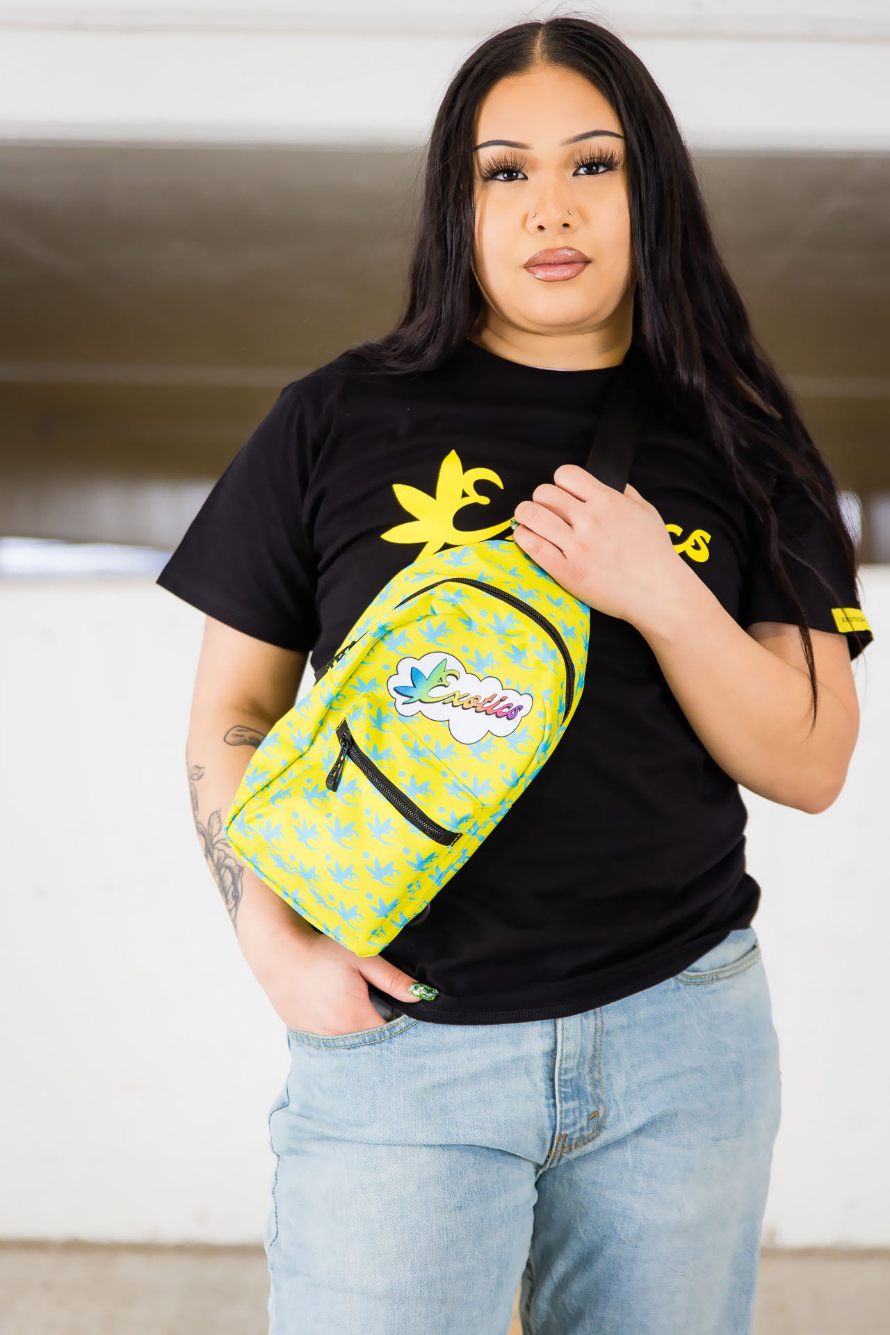 Woman holding yellow and blue Exotics crossbody shoulder bag